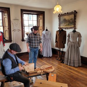Johnny Mackay demonstrating woodworking tools in the Parlour.