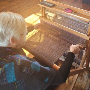 Vivienne Crawford weaving at the Saori loom